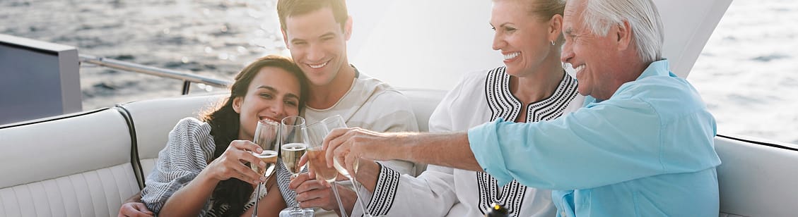 generational family celebrating with champagne on yacht