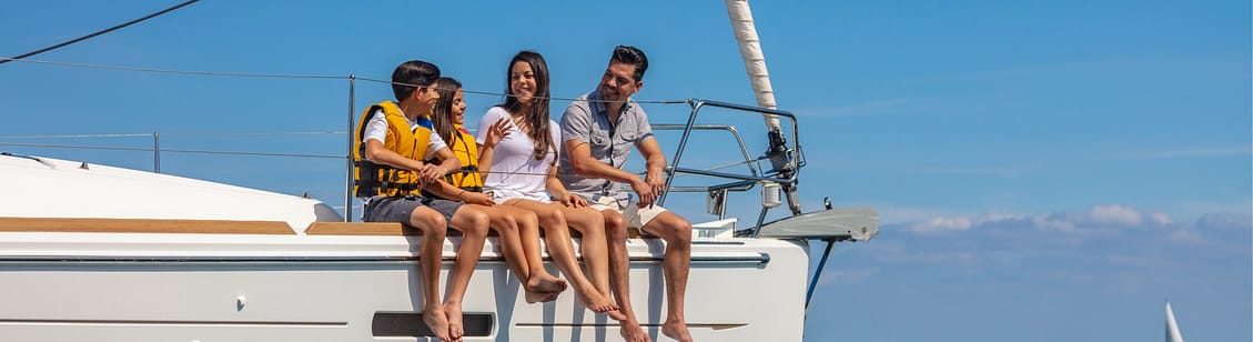 family sitting on luxury yacht