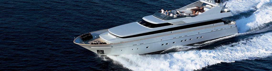 Luxury yacht cruising on open ocean, featuring sleek design and spacious sun deck, ideal for luxury travel and private charters.