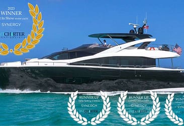 Luxury motor yacht Synergy cruising in turquoise waters, awarded 2023 Winner Best In Show with multiple runner-up accolades from BW Charter Yacht Society.